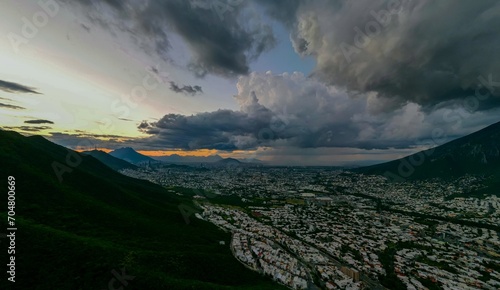 City Landscape with sunset and clouds of rain pouring above the city