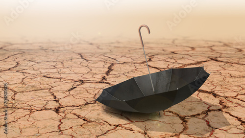 Umbrella on dry land caused by drought and lack of rain due to climate change photo