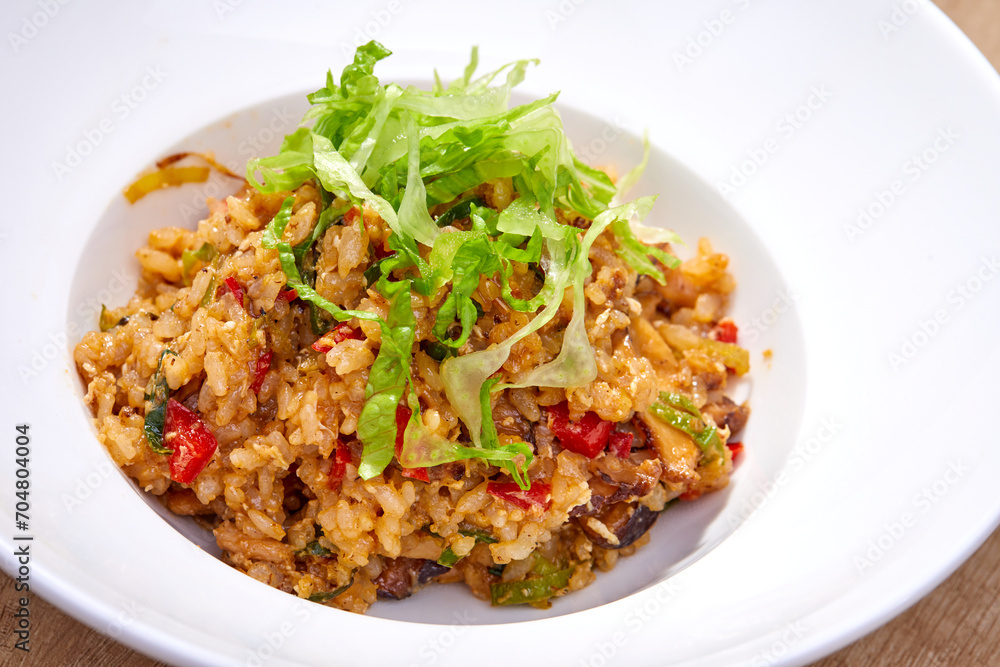 fried rice with vegetables on white plate