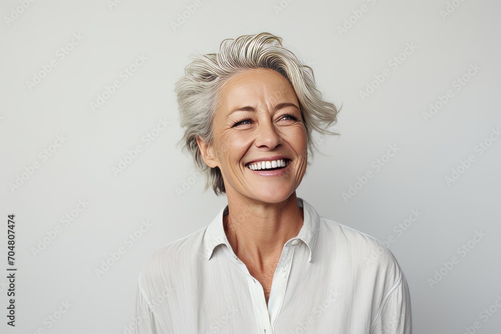 Happy senior woman smiling and looking at camera. Portrait of beautiful mature woman with grey hair. Happy senior woman smiling and looking at camera. Portrait of beautiful mature woman with grey hair.