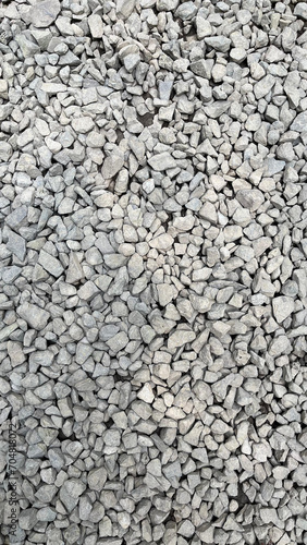 Rough texture of wall made of small gray cement pebbles. Small uneven gravel texture