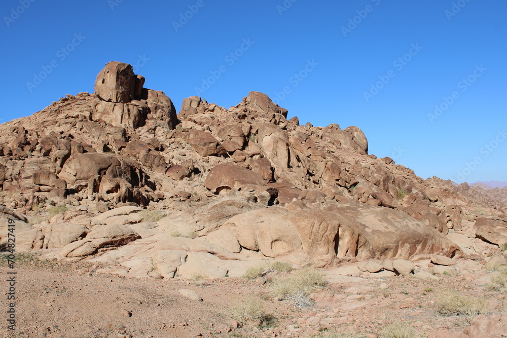A beautiful daytime view of the mountain range adjacent to Split Rock in Tabuk, Saudi Arabia. A beautiful daytime view of the mountain range adjacent to Split Rock in Tabuk, Saudi Arabia.