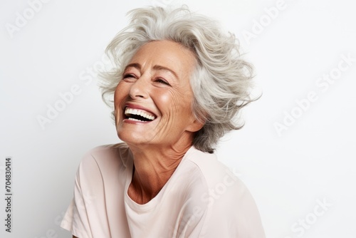 Close up portrait of a happy senior woman laughing isolated on white background