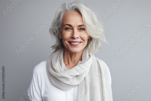 Portrait of a beautiful senior woman with grey hair wearing a scarf