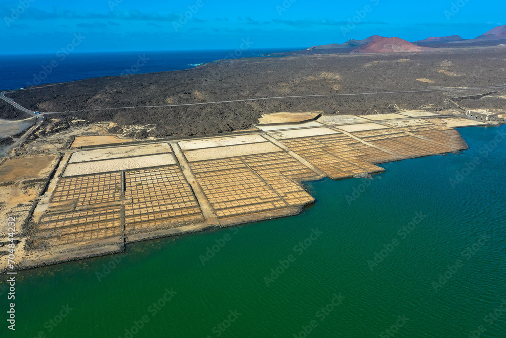 On the south coast of Lanzarote, near the fishing village of El Golfo, is the salt mining plant Salinas de Janubio, which is separated from the open sea by a headland. Aerial view. Canary Islands.