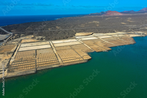 On the south coast of Lanzarote  near the fishing village of El Golfo  is the salt mining plant Salinas de Janubio  which is separated from the open sea by a headland. Aerial view. Canary Islands.