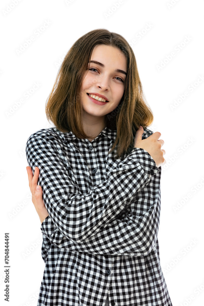 Embrace equity concept in a portrait of brunette eighteen year old girl, looks with happy expression. Young caucasian woman hugging herself and posing in studio. Embrace equity concept in a portrait of brunette eighteen year old girl, looks with happy expression. Young caucasian woman hugging herself and posing in studio.