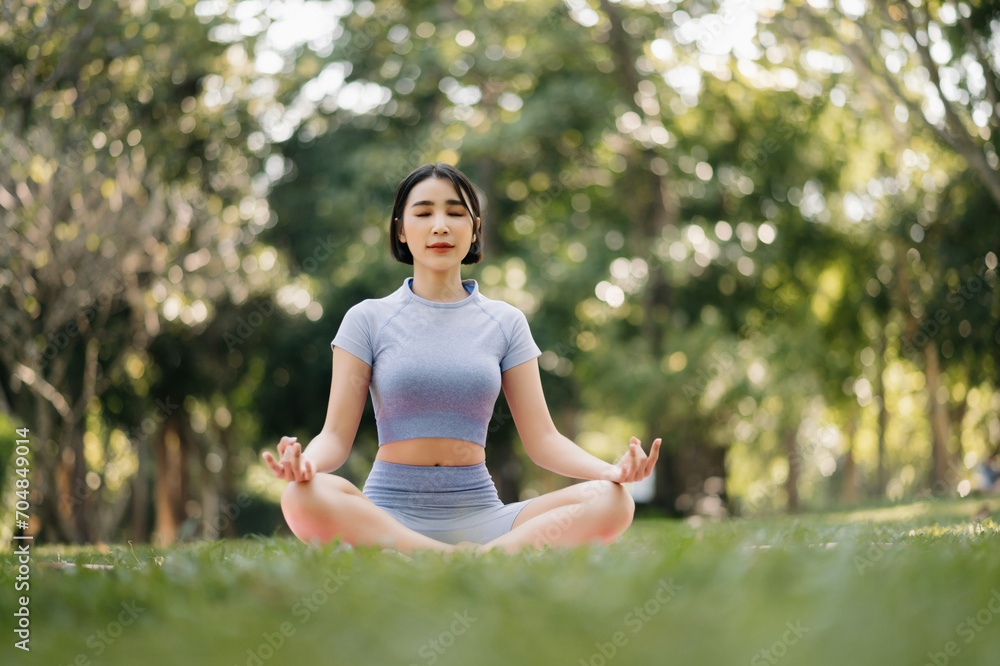 Portrait of young woman practicing yoga in garden.female happiness. in the park blurred background. Portrait of young woman practicing yoga in garden.female happiness. in the park blurred background.