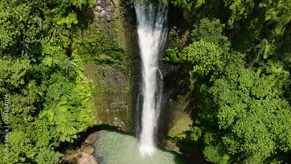 Drone view of waterfalls in the middle of greenery forest. Alalum Falls. Mindanao, Philippines. Drone view of waterfalls in the middle of greenery forest. Alalum Falls. Mindanao, Philippines.