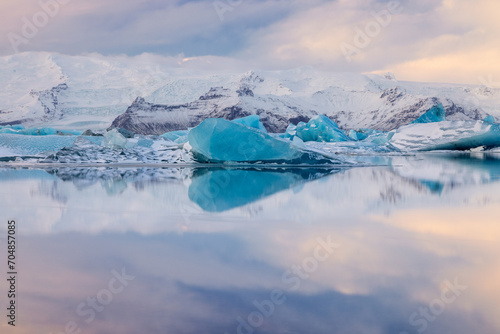 Blue heart-shaped iceberg reflection at Jokulsarlon Glacier lagoon in Iceland photo