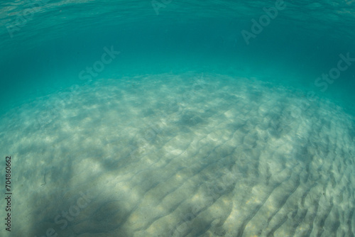 Deep blue ocean sand floor view.