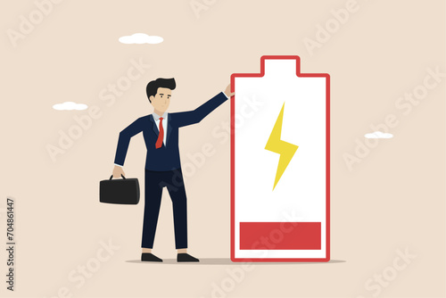 Exhausted and fatigue from hard work, stressed or anxiety from unhealthy work or depression and burnout, fatigue and tired businessman stand with low battery sign.