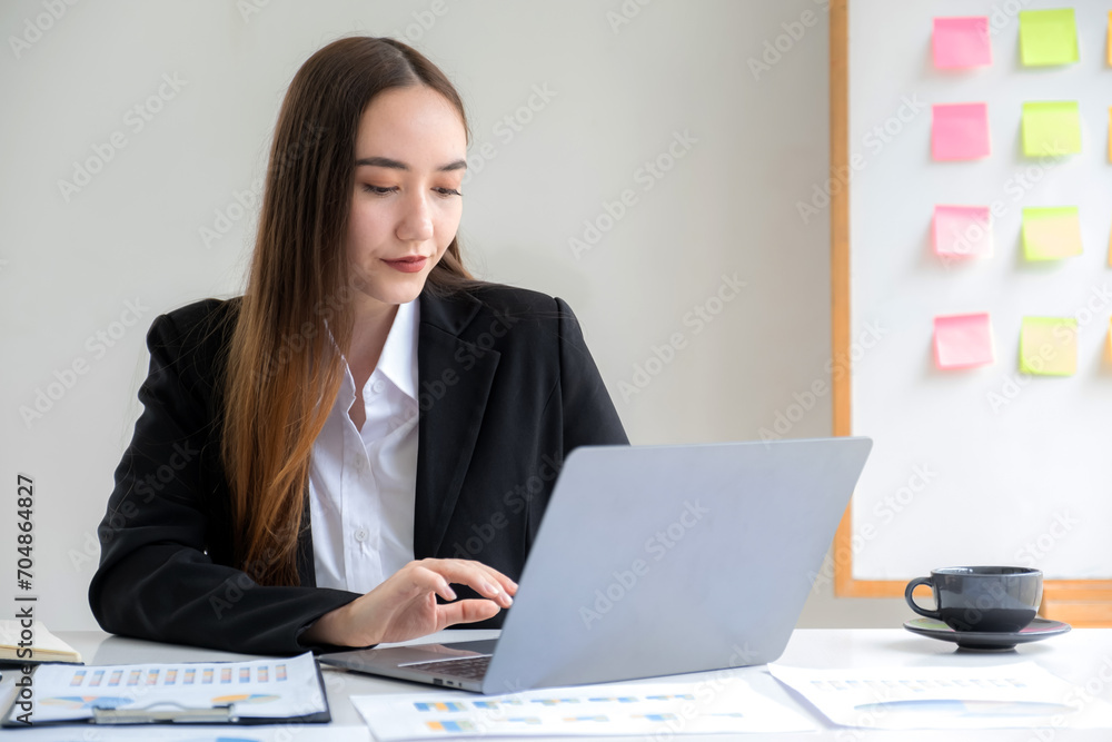 Businesswomen bookkeeper hand use laptop analysis the graph for Setting challenging business goals and ready to achieve target at home office Businesswomen bookkeeper hand use laptop analysis the graph for Setting challenging business goals and ready to achieve target at home office