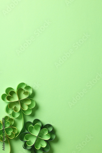 St patricks day background with clover paper cut art on green background.