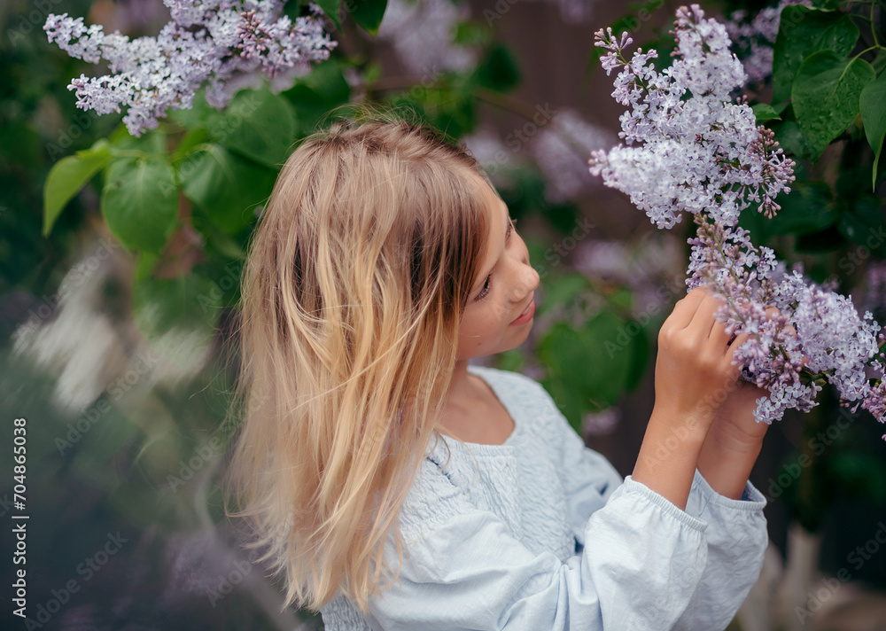 Fototapeta premium beautiful young girl with a bouquet of lilacs, a girl in lilacs, lilacs in spring. 