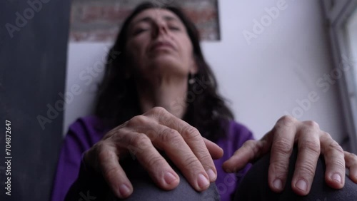 Adult Woman moving her fingers with anxiety while Coping Alone with Stressful Emotions. photo