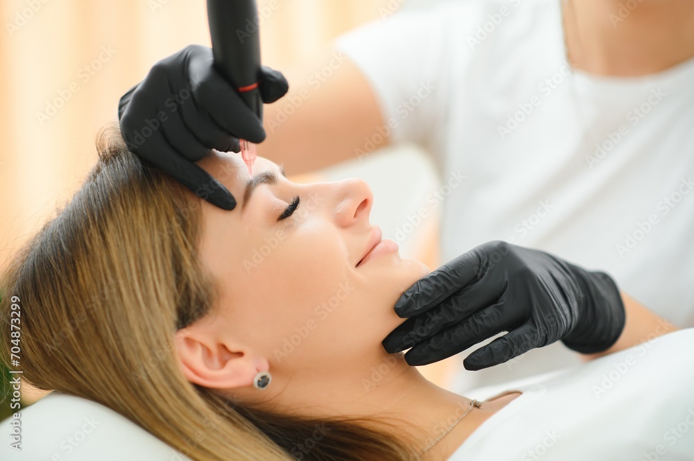 Fototapeta premium Permanent makeup. Permanent tattooing of eyebrows