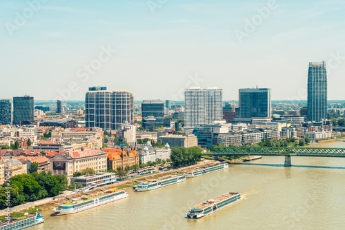 Slovakia, Bratislava Region, Bratislava, Danube river in summer with skyscrapers in background photo