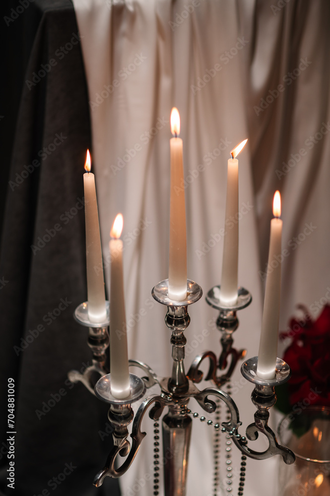 Burning candles for surprise marriage proposal. Luxury candlelight date in restaurant. Romantic dinner setup at night. Table set for couple, Valentine's Day evening. Decoration candle. Details closeup Burning candles for surprise marriage proposal. Luxury candlelight date in restaurant. Romantic dinner setup at night. Table set for couple, Valentine's Day evening. Decoration candle. Details closeup