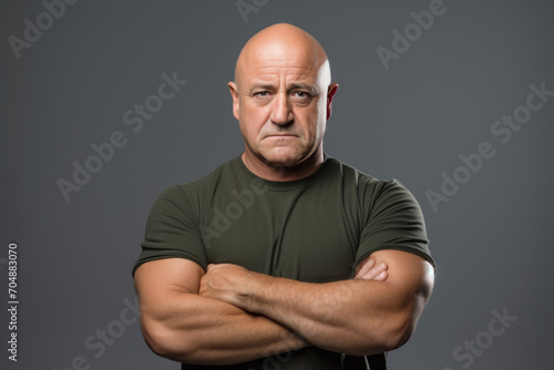 Strong muscle man standing with crossed hands