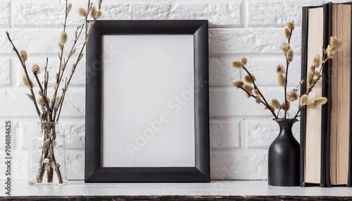 Mock up black frame and dry twigs in vase on book shelf or desk. White colors.