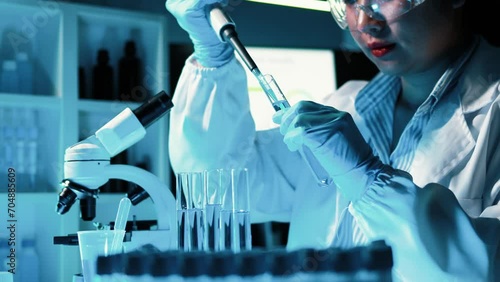 Lab assistant, a medical scientist, a chemistry researcher holds a glass tube through the blood sample, does a chemical experiment and examines a patient's blood sample. Medicine and research concept.