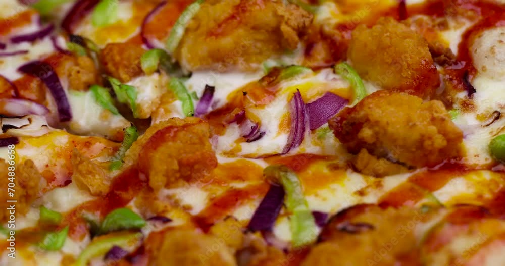 Fresh pizza with cheese and red onion with green pepper, large pieces of chicken meat on pizza Fresh pizza with cheese and red onion with green pepper, large pieces of chicken meat on pizza