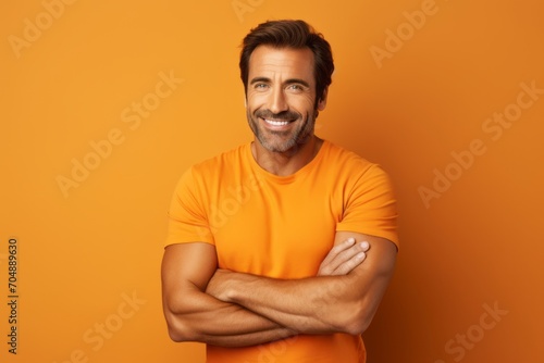 Handsome man in orange t-shirt on orange background.