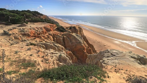 Arenosillo beach, located in Huelva, Spain. Explore the serene beauty of this coastal paradise with its sunlit sandy shores and the rhythmic ebb and flow of the Atlantic Ocean. photo