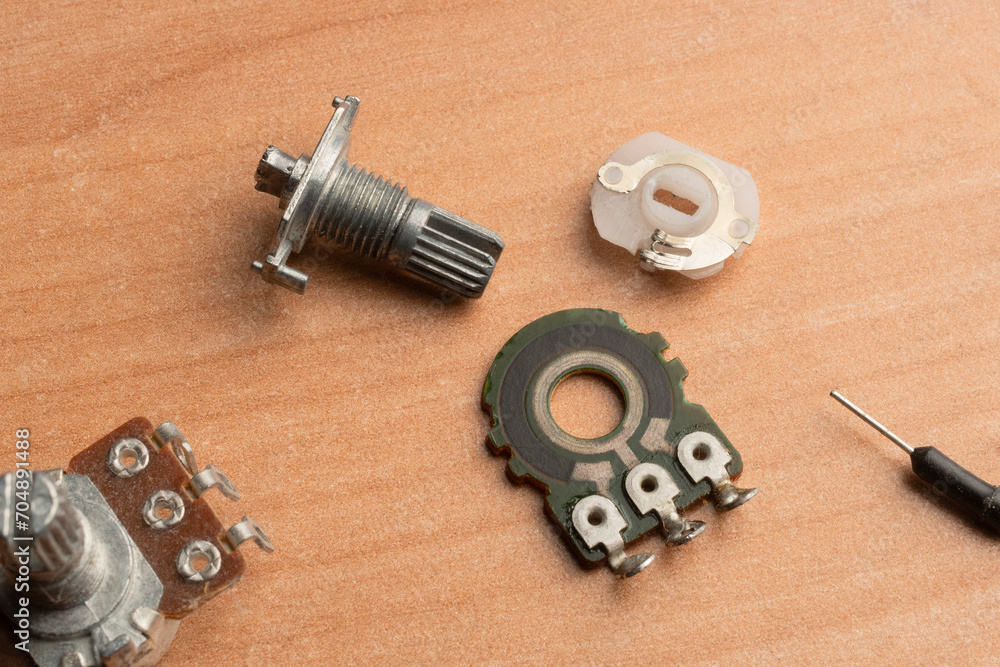 An electronic potentiometer disassembled into its functional parts An electronic potentiometer disassembled into its functional parts