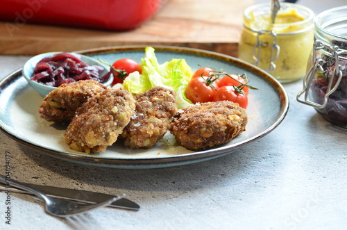 Meatballs with salad and cherry tomatoes on a plate. Selective focus.