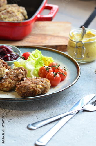 Meatballs with salad and cherry tomatoes on a plate. Selective focus.