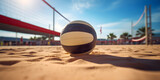 A volleyball on the beach with a net, Beach volleyball court with a volleyball ball placed in the sand.