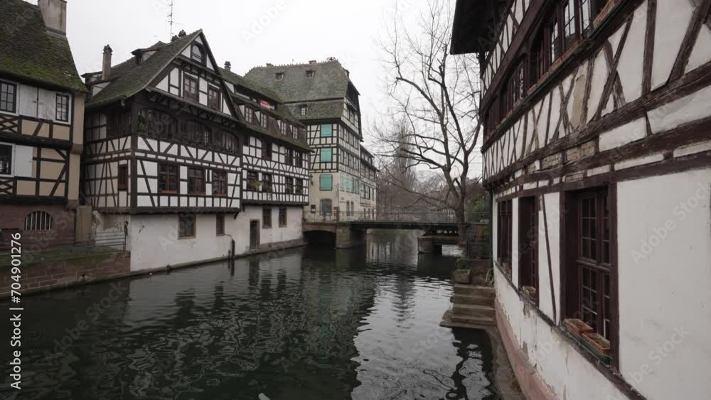 Overlooking the tranquil river waters within the charming canals of Strasbourg, Alsace, France. The reflections in the water mirror the architectural beauty that graces the water's edge. Overlooking the tranquil river waters within the charming canals of Strasbourg, Alsace, France. The reflections in the water mirror the architectural beauty that graces the water's edge.