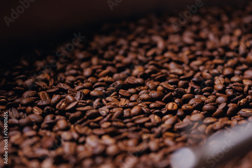 Macro fresh brown roasting coffee beans, warm light toning dark background