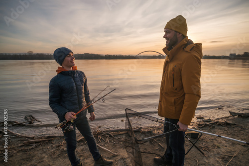 Father and son are ready for fishing on winter day. Freshwater fishing.