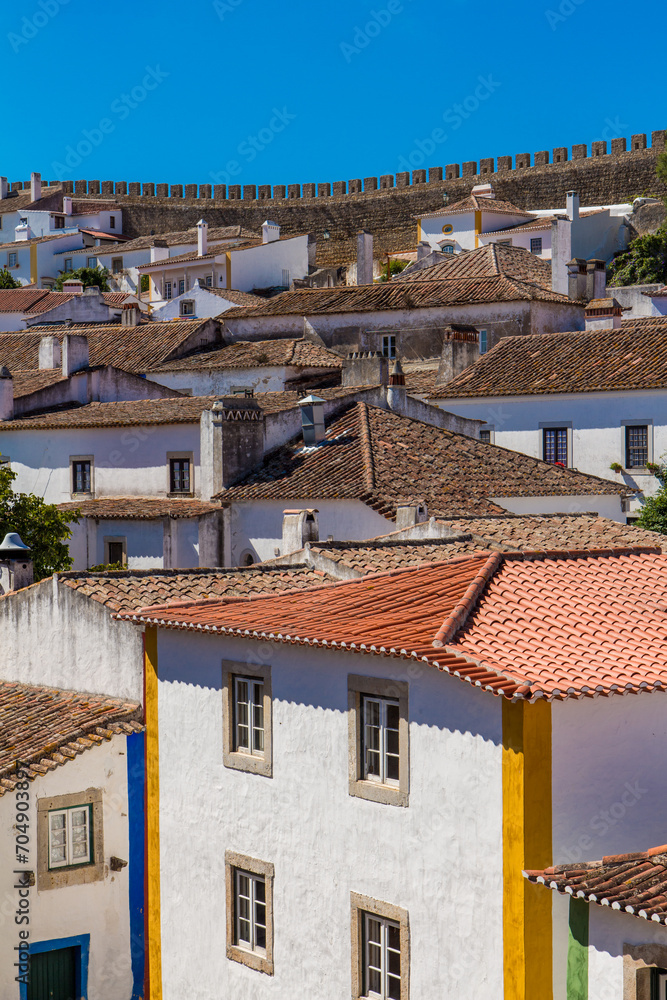 The wall and cityscape of Obidos. Medieval Óbidos is one of Portugal's most famous sights. The colorful fortified town has been beautifully restored. The wall and cityscape of Obidos. Medieval Óbidos is one of Portugal's most famous sights. The colorful fortified town has been beautifully restored.
