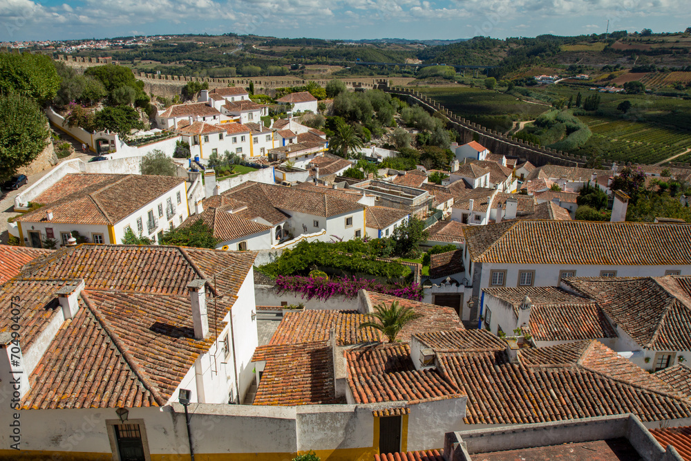 Cityscape of Obidos. Medieval Óbidos is one of Portugal's most famous sights. The colorful fortified town has been beautifully restored. Cityscape of Obidos. Medieval Óbidos is one of Portugal's most famous sights. The colorful fortified town has been beautifully restored.