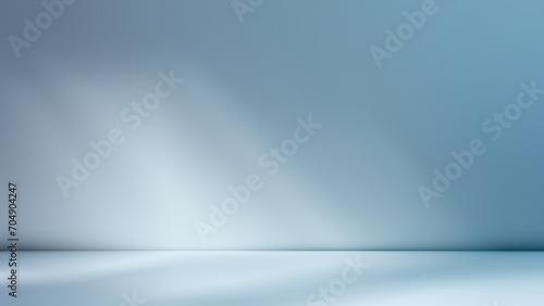 Minimalistic simple abstract light blue background for product presentation. Shadow and light from windows on wall.