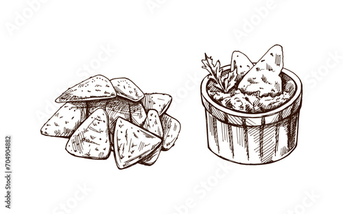 Hand-drawn sketches of bowl with guacamole, nachos and parsley leaves with a handful of nachos. Vintage drawing. Vector food sketch illustration. Illustration for menu. Latin America.