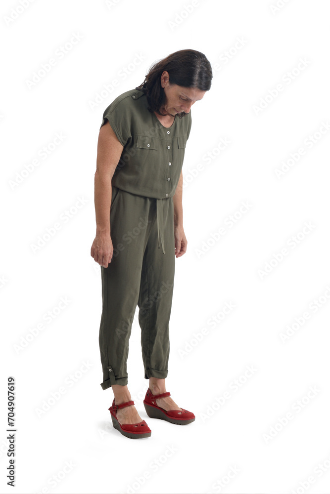 View of a woman standing looking at the floor searching for something on white background. View of a woman standing looking at the floor searching for something on white background.