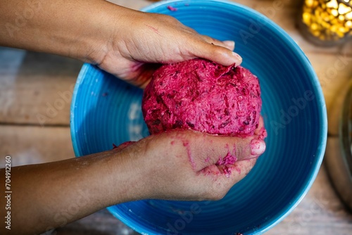 wheat dough, Healthy Beetroot Thepla dough. Beetroot Paratha dough. in women hand closeup view. Pink dough. photo