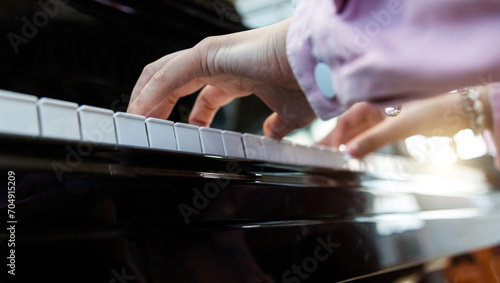 Close up of woman hands playing piano © xy