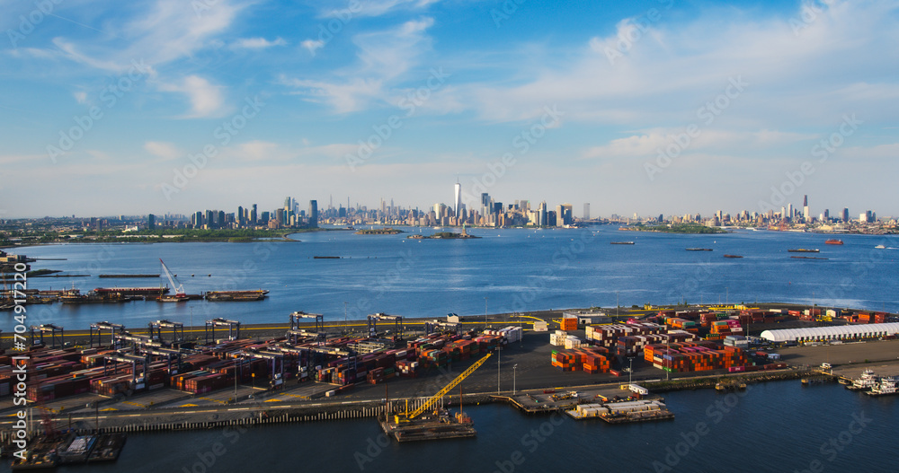Aerial View of Manhattan Architecture. Panorama of New York City and Jersey City From a Helicopter, Showing Office Buildings and Skyscrapers. Camera Flies Over a Harbour Area with Shipping Containers