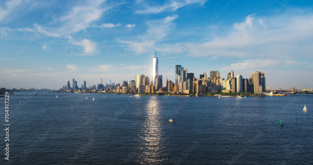 Aerial View of Lower Manhattan Architecture. Panoramic Shot of Wall Street Financial District from a Helicopter. Office Buildings Scenery with Water Transportation in the Hudson River