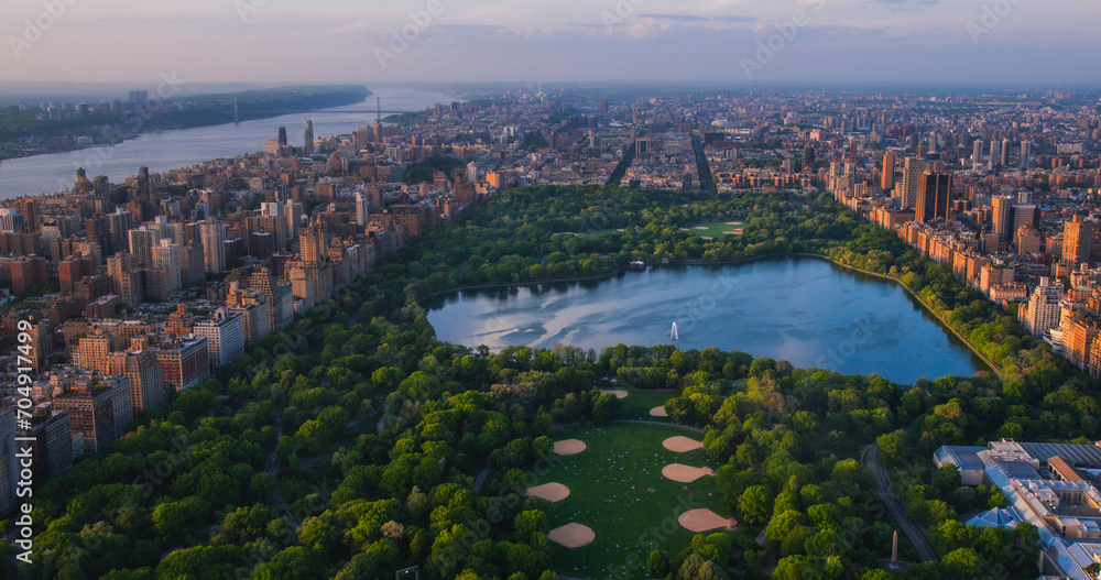 Helicopter Tour of New York City Architecture. Central Park Panoramic View of Office Buildings and Skyscrapers of Manhattan in a Warm Evening Sunlight