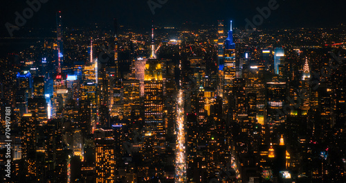 Aerial Night View of New York City Avenues in Manhattan  Business and Residential Building Roofs  Cars and Commercial Vehicles Driving at Night. Helicopter View a Straight Roads with Traffic