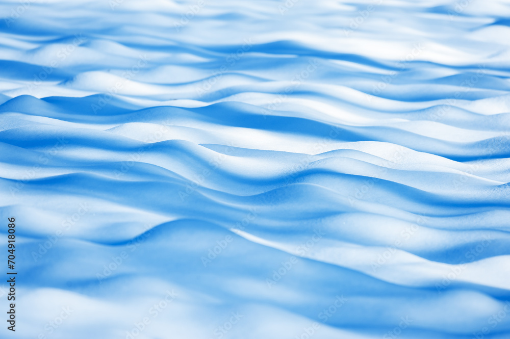 Wavy abstract winter background on snow covered field. Nature texture Wavy abstract winter background on snow covered field. Nature texture