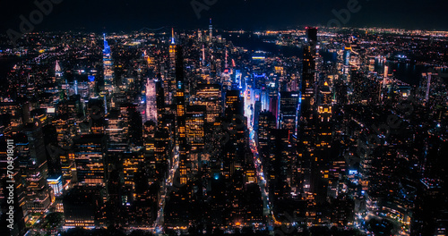 Aerial View of Midtown Manhattan Architecture at Night. Evening Shot of Financial Business District from a Helicopter. Scenery of Historic Office Towers, Including Illuminated Empire State Building