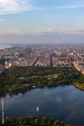 New York Cityscape During Daytime. Aerial Photo from a Helicopter. Modern Skyscraper Buildings Around Central Park in Manhattan Island. Focus on Nature, Trees and Lakes in the Park in the City